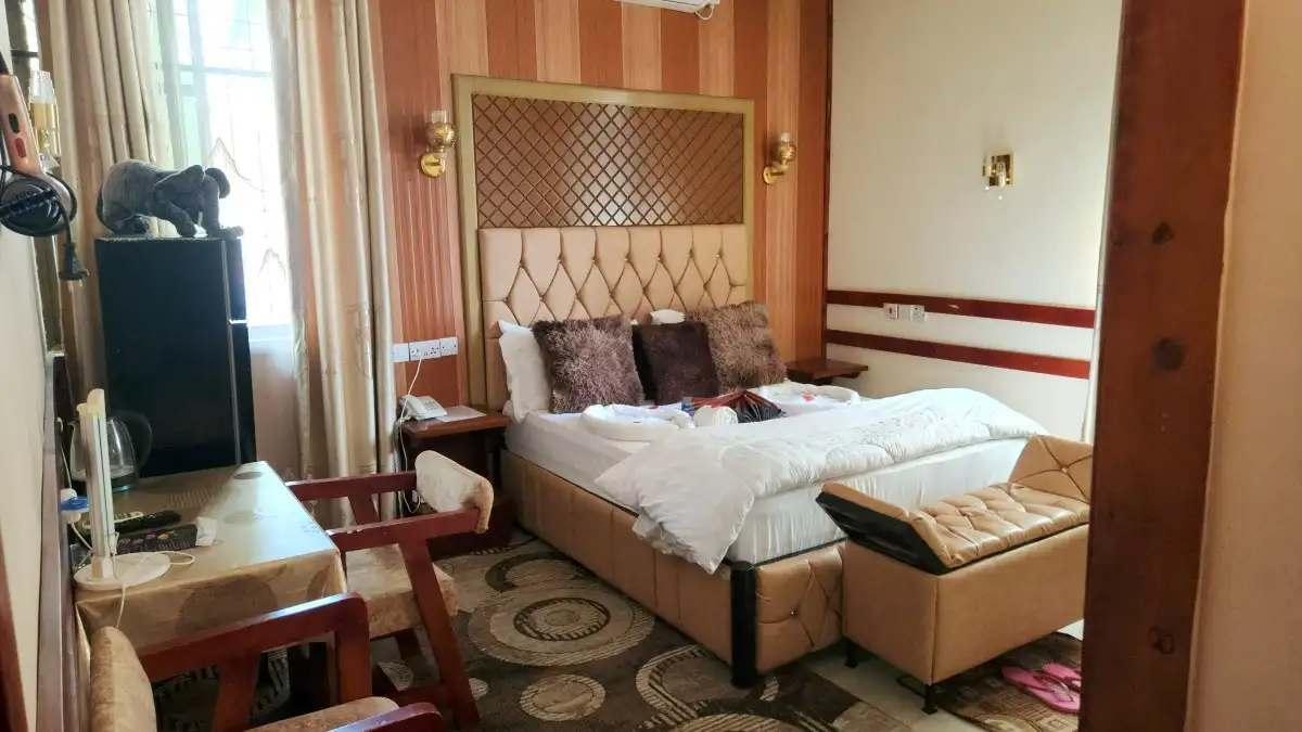 Double room in natural daylight with desk and seating